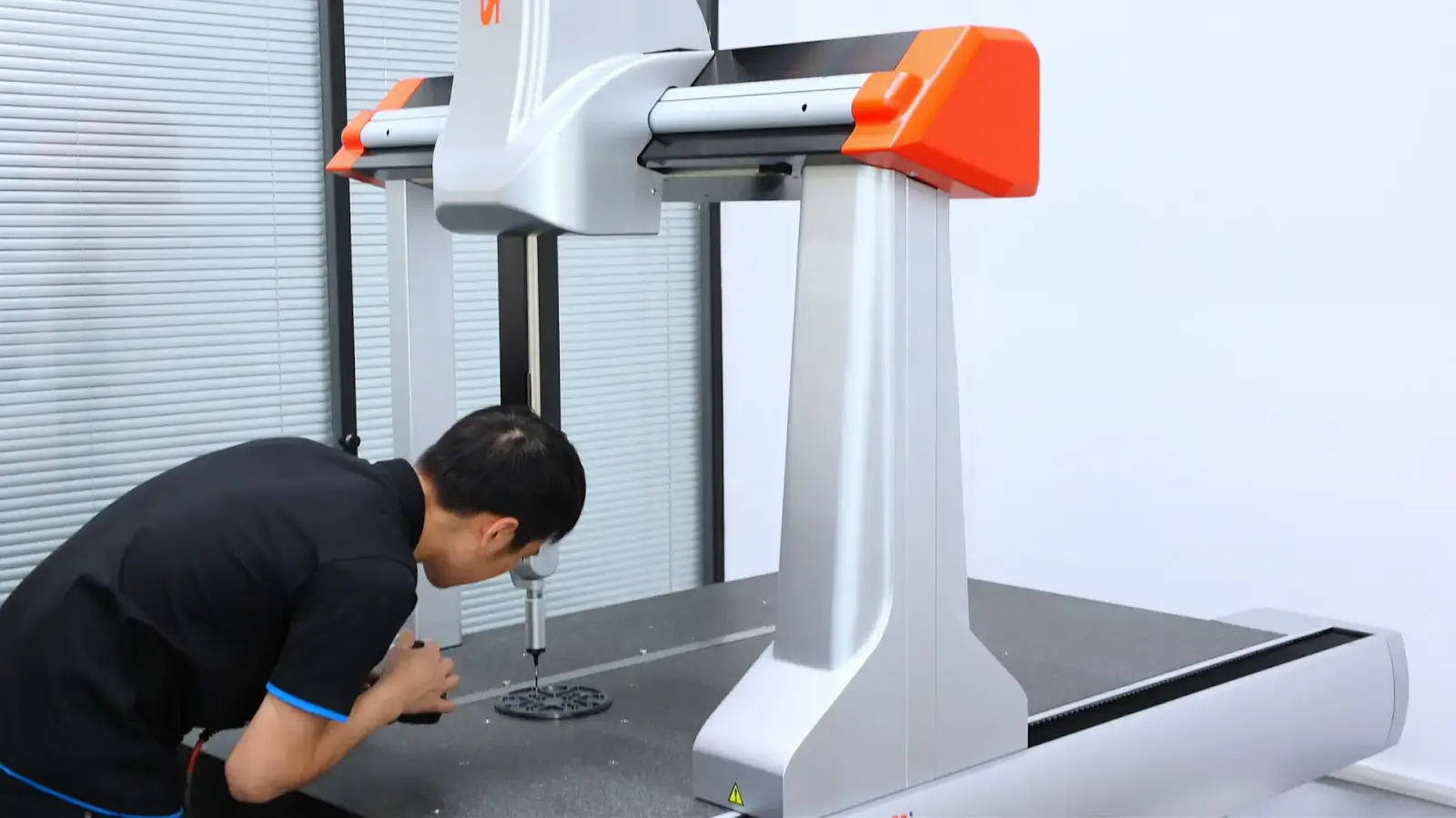 Technician Using A Cmm Coordinate Measuring Machine For Precision Part Inspection